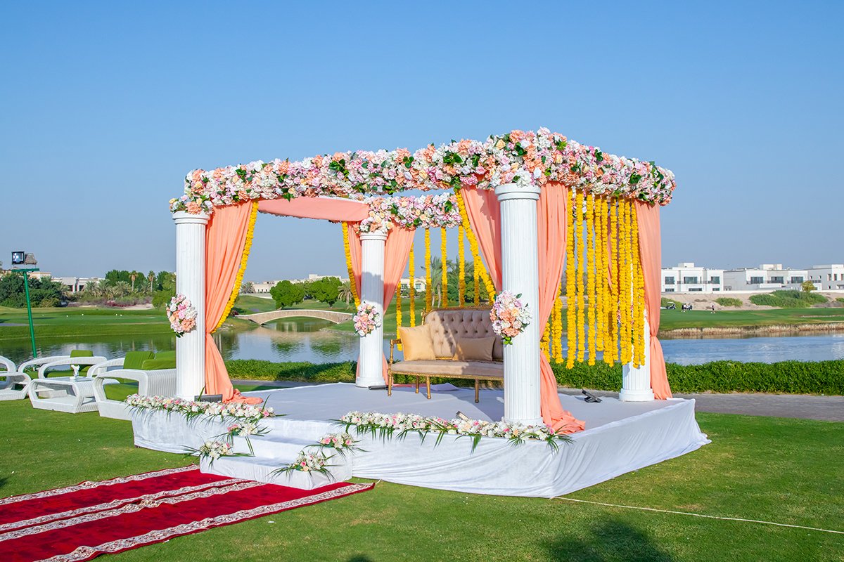 Traditional Indian wedding mandap with floral pillars and draping